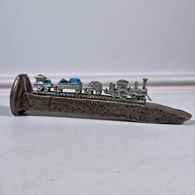 Pewter Train | Miniature train with turquoise on a large railway nail. - h. 2 x w. 1 x l. 7 in
Pewter Train | Miniature train with...