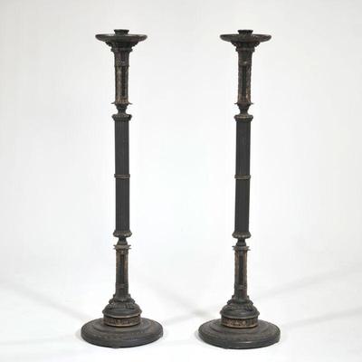 (2pc) Large Patinated Metal Floor-standing torchieres | Black metal pair of column candle stick holders on round bases with carved...