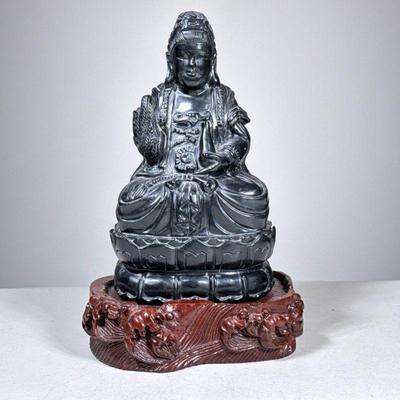Carved Black Stone Buddha | Heavy, on a carved conforming wood stand. - h. 7.75 x w. 4.5 x d. 4 in

