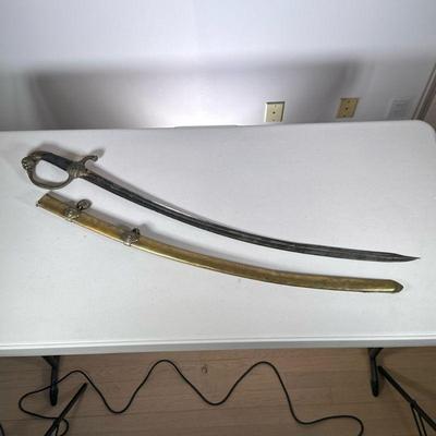European Sword & Brass Scabbard | Likely French or German, brass and metal military sword, the handle with lions head, scales, and...