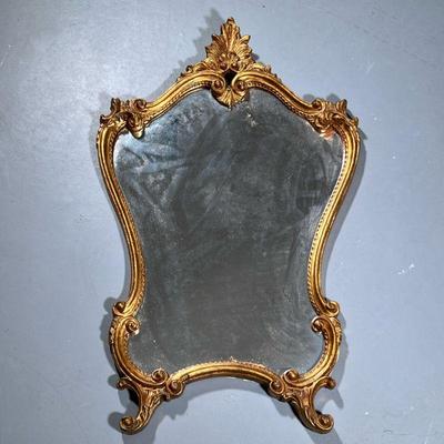 Mirror in Gold Gilt Frame | Carved gilt wooden framed mirror with acanthus crest and scrollwork. - h. 35 x w. 22 in


