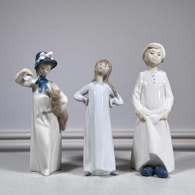 (3pc) Lladro Figures | Lladro porcelain figurines, including a young lady with bonnet and cat, lady in nightgown and defiant lady with...