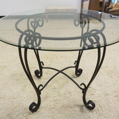 Sale Photo Thumbnail #170: 1171	GLASS TOP BEVELED EDGE TABLE WITH WROUGHT IRON BASE, APPROXIMATELY 42 IN X 30 IN H
