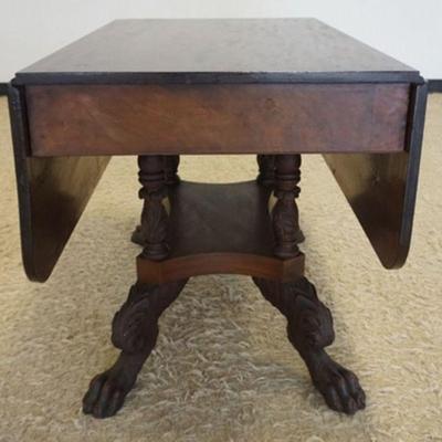 1161	EMPIRE MAHOGANY DROP LEAF TABLE, TABLE HAVING 4 CARVED COLUMNS AND CARVED CLAW FEET AT BASE, APPROXIMATELY 40  IN X 25 IN X 27 IN H,...