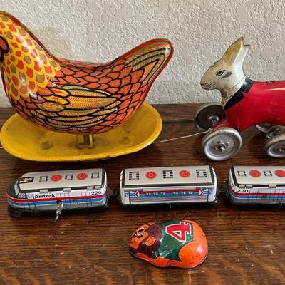 Vintage Tin Toys - Amtrak Wind Up Train, Laying Egg Hen, Pull String Bunny, And A Wind Up Lion (as Is)