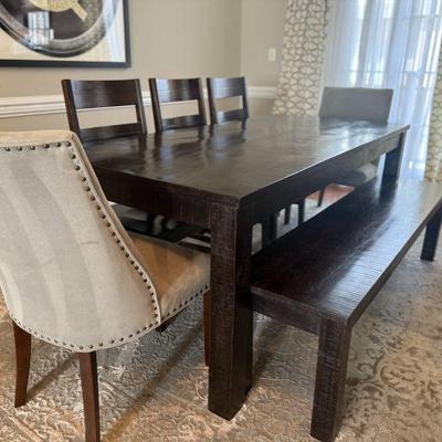 Pier One wood dining table with bench, 3 wood chairs and 2 upholstered chairs.  Table shows some wear.  76" x 36"