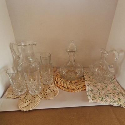 Assorted Glassware, Decanter And Pitchers With Doilies