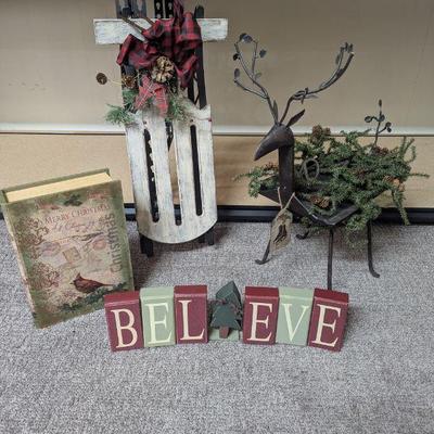 Lot #117 - Christmas Decor Lot - Wooden Sled, Rustic Reindeer Planter, 'Believe' Blocks, and Merry Christmas Book.