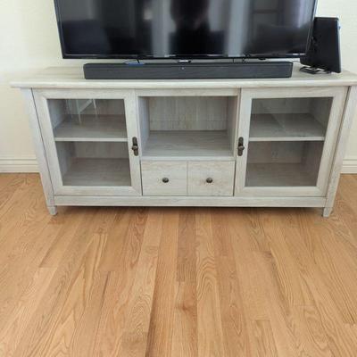 Lot #1 - Modern TV Stand - Whitewashed Wood Finish with Glass Doors.