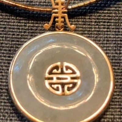 Jadeite pendant set in 14k gold