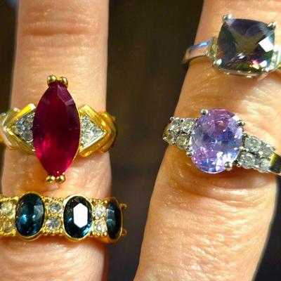 Costume jewelry rings (faux garnet, faux sapphire, fire topaz and pastel purple stone )