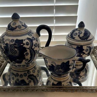 Blue pattern tea pot with sugar and creamer on silver mirrored platter