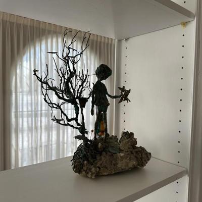 Girl Feeding Birds bronze statue by Arnold Snyder. Base is sandstone, mica and granite. Flowers are coral. 