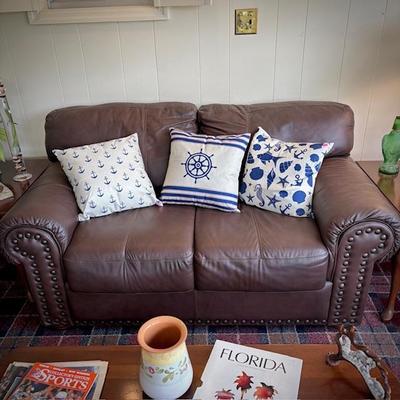 Brown leather loveseat