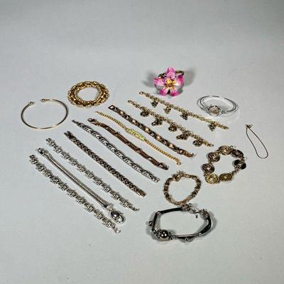(16pc) GOLD & SILVER TONED BRACELETS | Large lot of gold and silver toned costume bracelets including: elephant bracelet, Chinese...