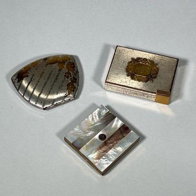 (3pc) MAKEUP COMPACTS | Including: inlaid mother of pearl makeup compact, Elgin American seashell shape compact, and engraved...