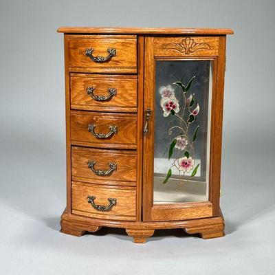 JEWELRY CASE | Carved wood jewelry case with painted glass door with necklace holder and 5 felt-lined drawers. Dimensions: h. 14 x w....