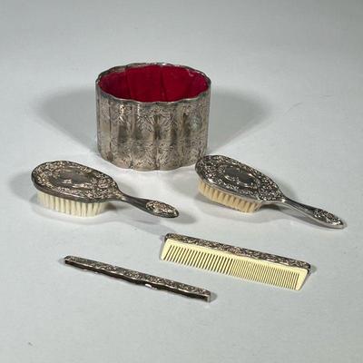 (5pc) SILVER PLATE BRUSHES & COMBS | Including: pair of engraved silver plate brushes, pair of tooled silver plate comb holder &...