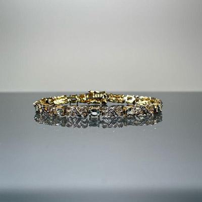 AQUAMARINE STERLING TENNIS BRACELET | Very light blue gemstone and diamond sterling silver bracelet having a gold-tone finish, with ten...