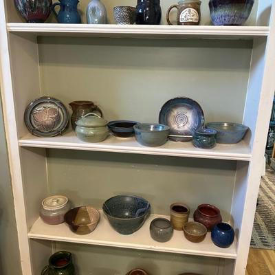 Many pieces of pottery, several by Susan DeMay