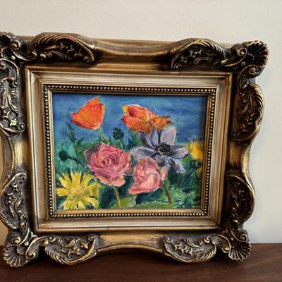 Brightly colored impressionistic floral painting. Signed by the artist. Measures 13 1/2“ x 15 1/2“ $125