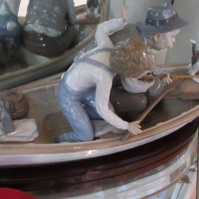 Hall lladro of man boy and dog in a boat