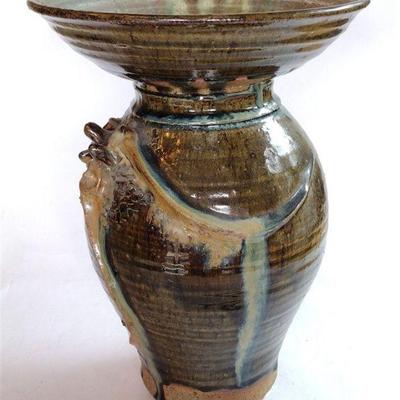 unusual bowl placed atop pottery