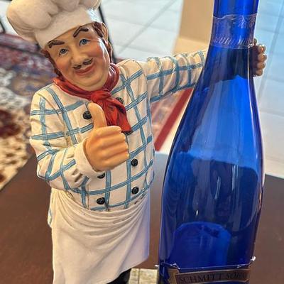 White/blue Chef Holding Wine Bottle