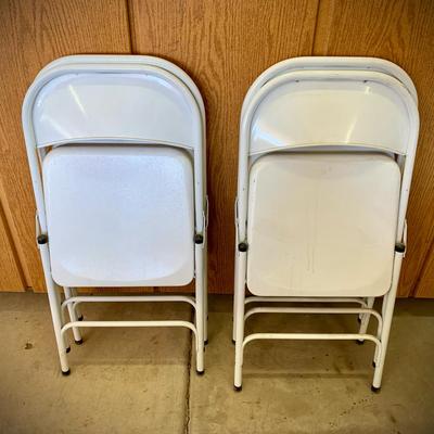 Four White Folding Metal Chairs