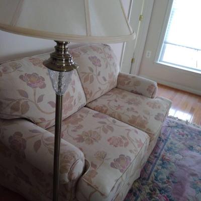 Floral Upholstered Loveseat And Floor Lamp