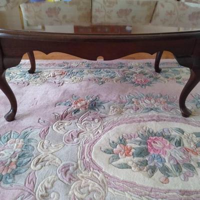 Dark Wood Coffee Table And Floral Area Rug