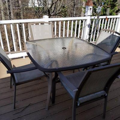 45" X 29" Metal Framed Glass Top Table And Four Armchairs