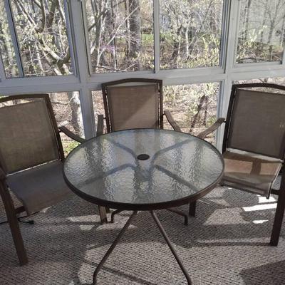 Metal Framed Glass Top Table With Three Metal Framed Patio Chairs