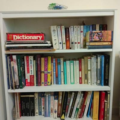 Three Tier White Bookshelf Filled With An Assortment Of Books