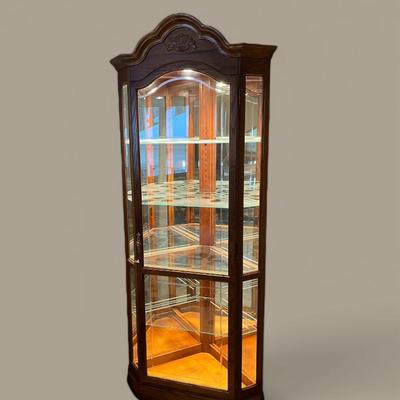 Howard Miller Cherry Serpentine Illuminated Corner Curio Cabinet