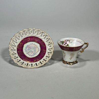 Invicta Cup & Saucer | With gilt highlights, the saucer with reticulated rim, marked on the bottom "Invicta Japan"....