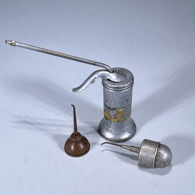 (3pc) ANTIQUE & VINTAGE OIL CANS | Including: Eagle pump oil can, small round oil pump can, and copper or brass oil can Dimensions:...