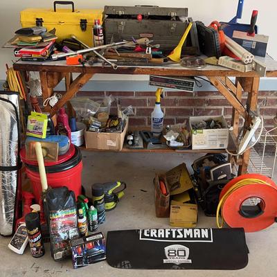 Wooden Work Bench With Lots Of Tools And Car Cleaning Items