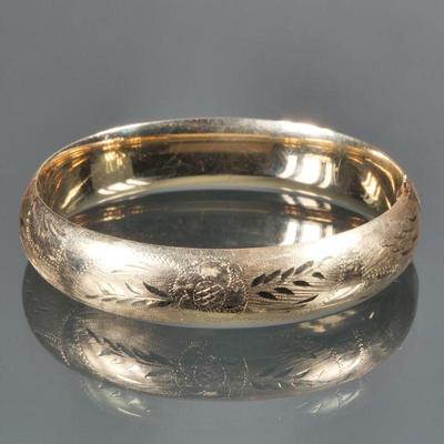 ENGRAVED 14K GOLD HINGED HARD BRACELET | 14K yellow gold bracelet with engraved floral pattern, marked "14K"; 19g. - w. 2.5 x...