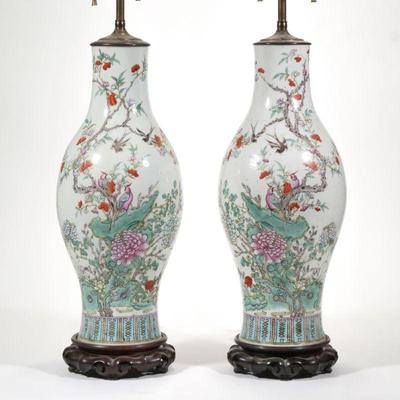 PAIR CHINESE FAMILLE ROSE LAMPS | A pair of porcelain vases with mirrored enameled decoration of bids among flowering branches, mounted...