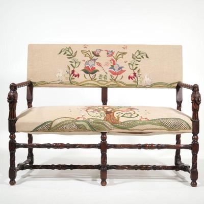 JACOBEAN FIGURAL CARVED SETTEE | Each hand hold carved with a full figure grasping a flower, the frame, supports, and stretcher with...
