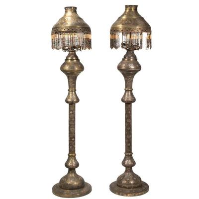 (2pc) FINE MOORISH MIXED METAL FLOOR LAMPS | A near pair of mixed metal floor lamps with embossed patterns and arabic writing in silver...