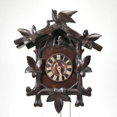 "BLACK FOREST CUCKOO CLOCK | late 19th/ early 20th century, crested by a bird with maple leaves, with carved wood pendulum and...