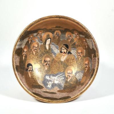 JAPANESE GILT SATSUMA BOWL | The interior and exterior depicting figures amongst a dragon, with signature to underside
h. 4 x dia. 9.75 in.
