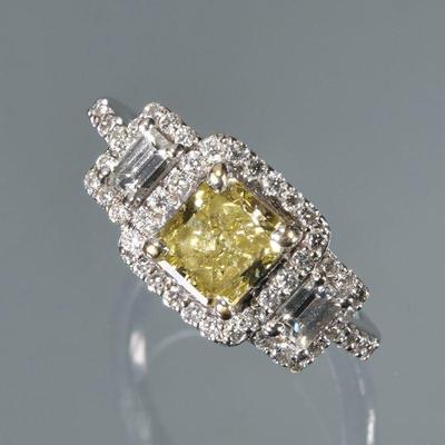 SQUARE CUT FANCY YELLOW DIAMOND RING | Designed as a square princess or Asscher cut fancy yellow diamond (5.85 x 5.35 x 3.4 mm) flanked...