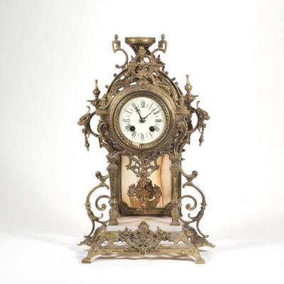 "GUSTAV BECKER ONYX & BRASS SHELF CLOCK | Having ornate gilt brass scroll work and carved onyx
h. 17 x w. 7.5 x l. 11 in."