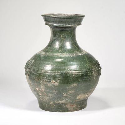 CHINESE ANTIQUE GREEN GLAZED VASE | Likely Han dynasty; A bulbous pottery vase with deep green glaze throughout, slightly flared rim, and...