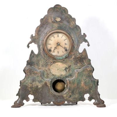 "UNUSAL CAST IRON SHELF CLOCK | Paint-decorated cast iron front
h. 20 x w. 18 x d. 4.75 in."