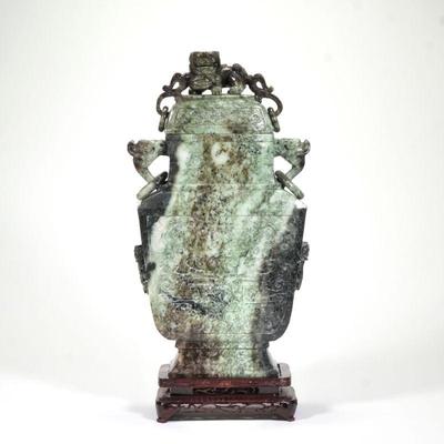 MONUMENTAL CHINESE CARVED AGATE VASE | A lidded vase with overall carved decoration, the vase with side handles with o-rings, the lid...