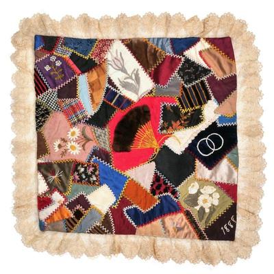 19TH CENTURY EMBROIDERED PATCHWORK PANEL | having small shaped fragments of fabric stitched together and embroidered with flowers and an...